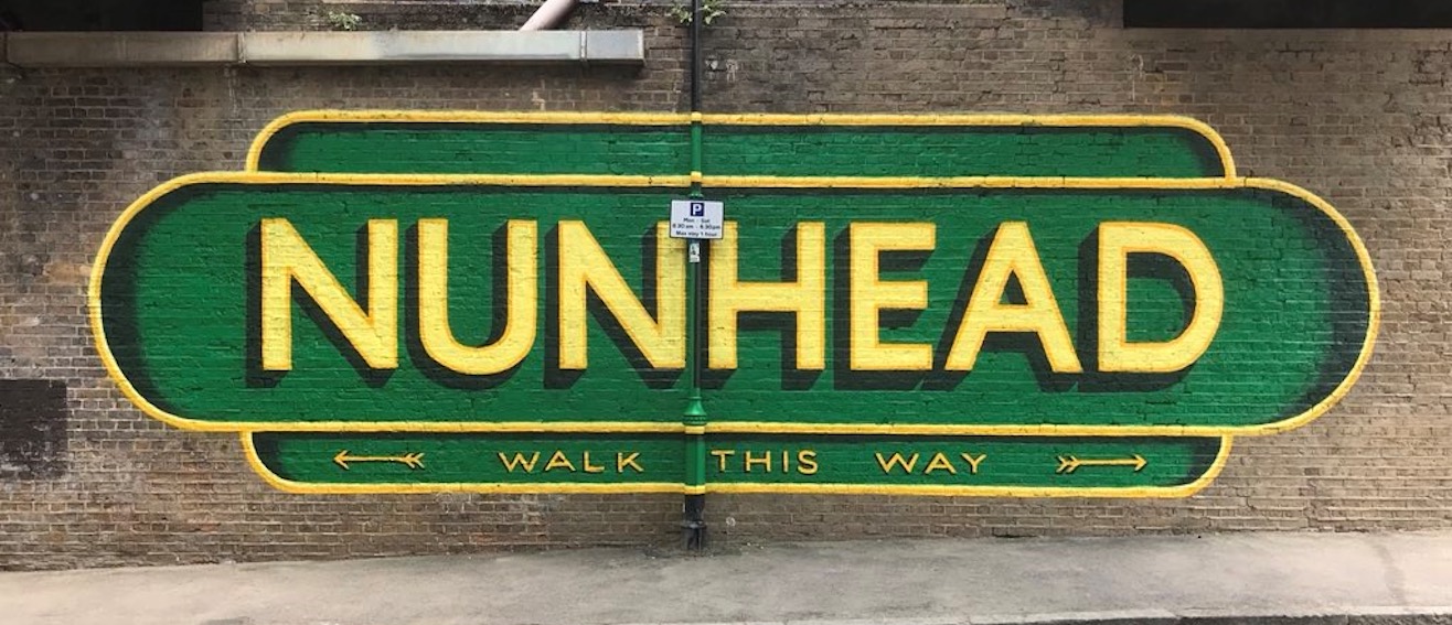 Yellow writing on wall saying Nunhead