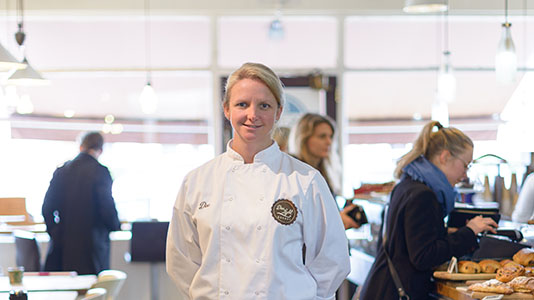 Dee in the customer area of Dee Light Bakery