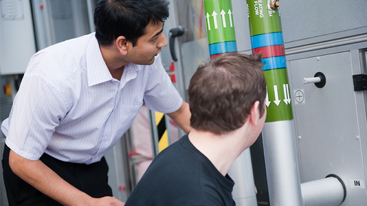 Students examine ventilation pipes