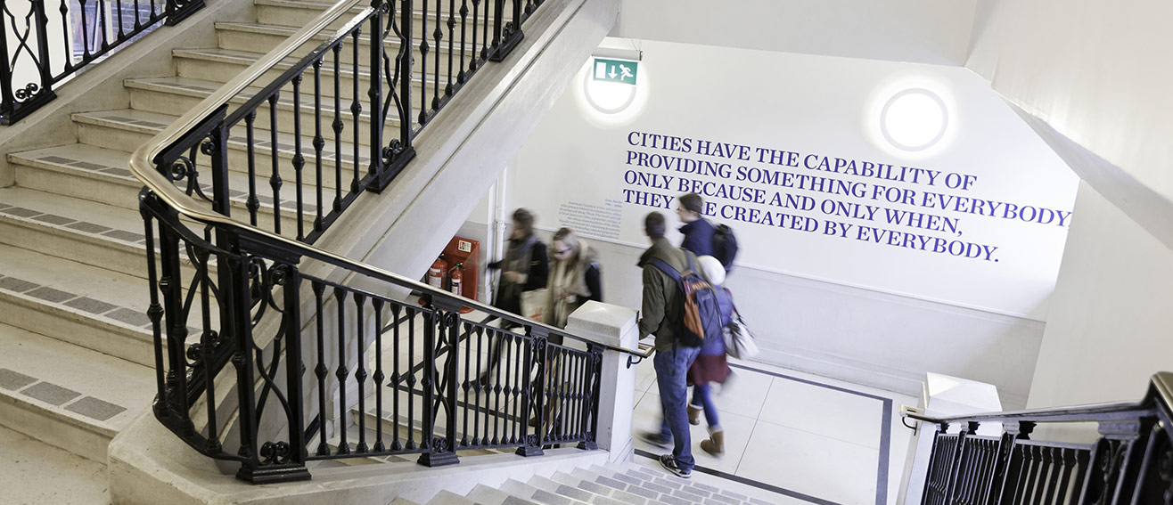 students on a staircase, wall quote