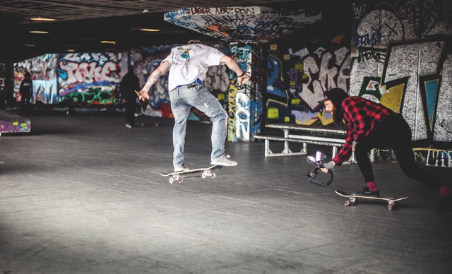 woman films man skateboarding