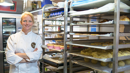 Dee with trays of her baked products