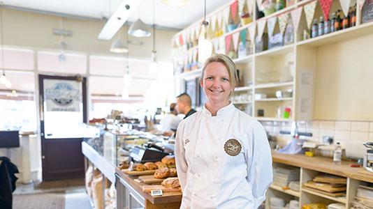 Dee next to the bakery counter