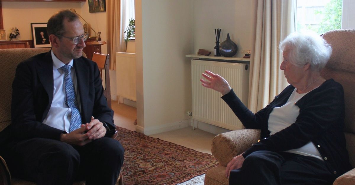 Paul Kett and Dr Agnes Kaposi talk inside a house