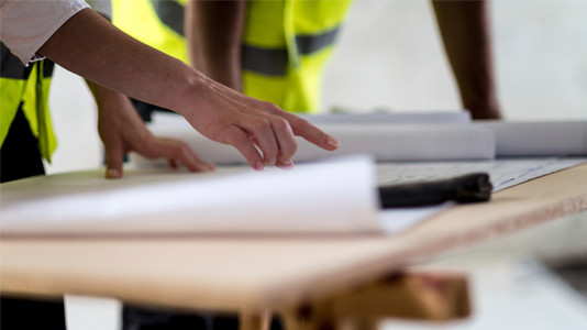 Construction workers consulting plans