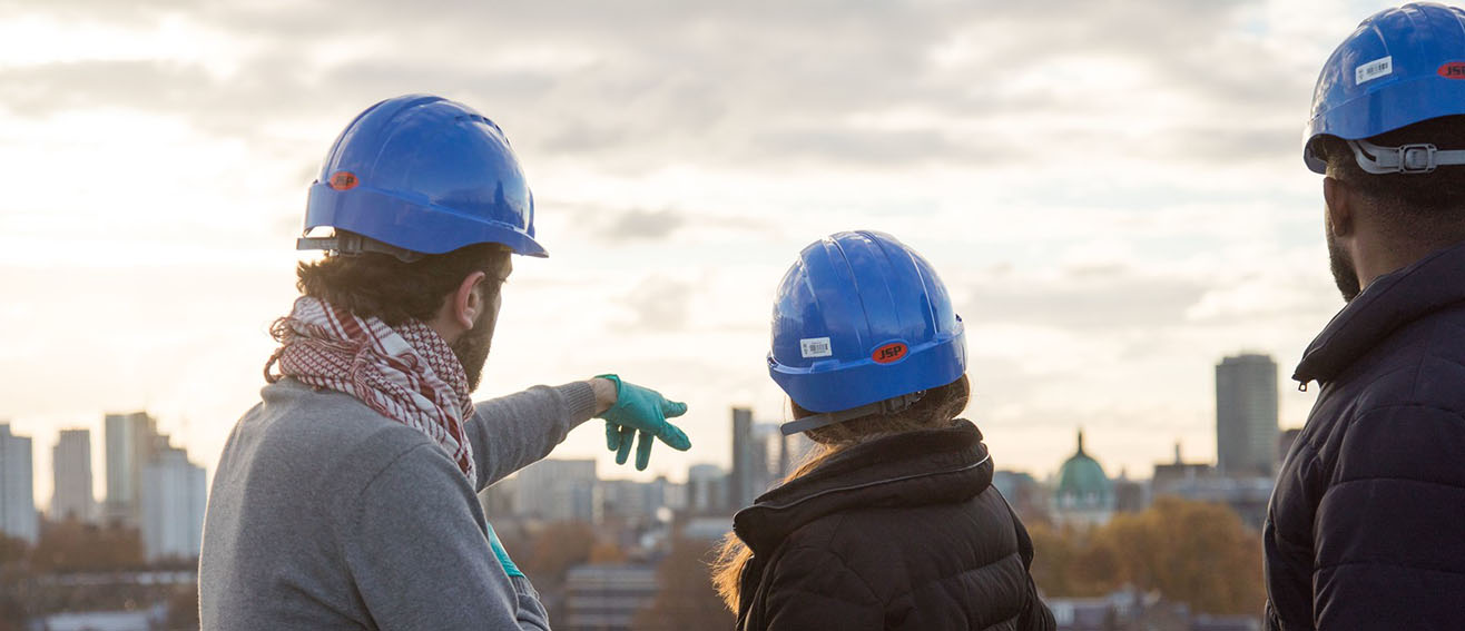 Students in construction hats scan skyline 1316x567