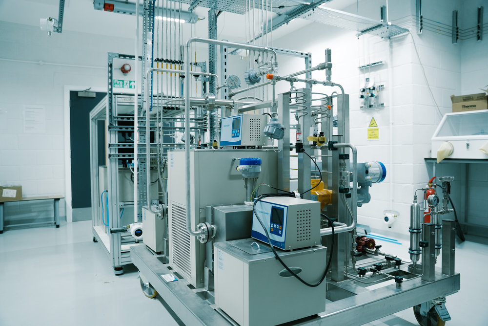 Metal‑hydride hydrogen test rig with thermal‑control units and connected pipework inside a purpose‑built LSBU laboratory