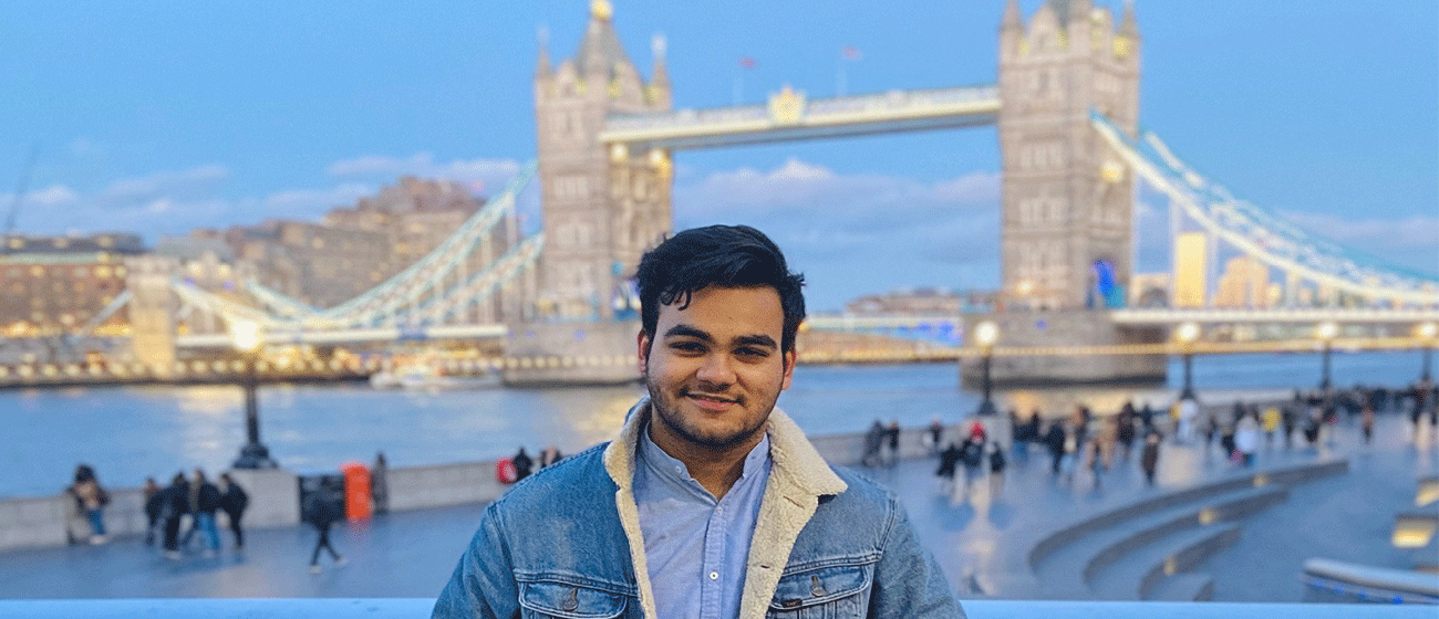 student in front of Tower Bridge