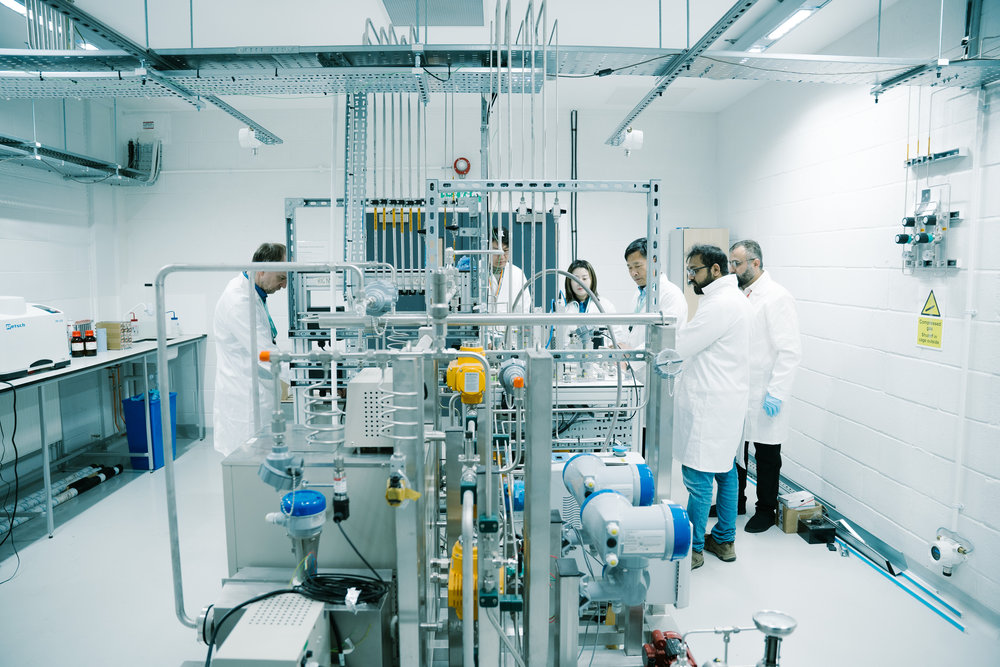 Wide shot of LSBU’s hydrogen laboratory showing multiple metal‑hydride test rigs, pipework and monitoring equipment.