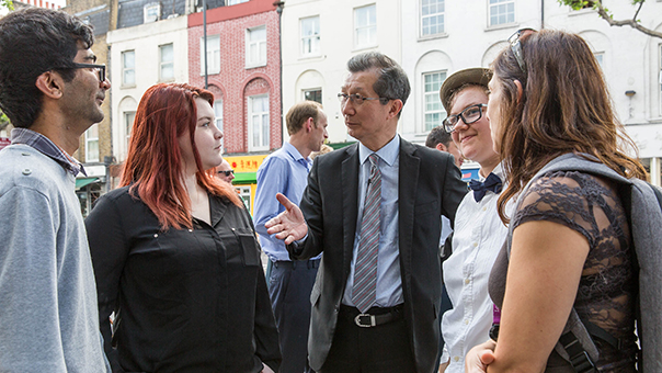 Minister Chan speaks to the students behind the Live Portal