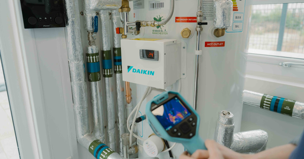A person holds up a heat mapping tool