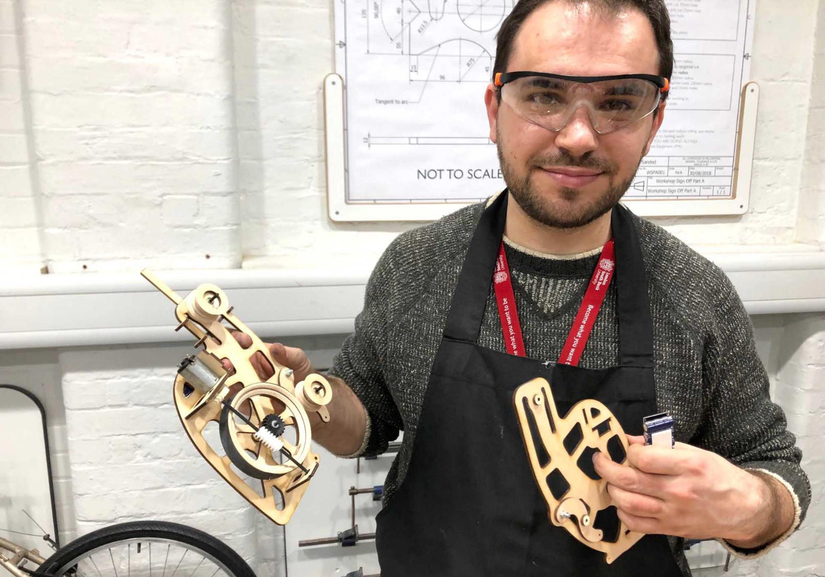 Andrei our finallist man holds things he made